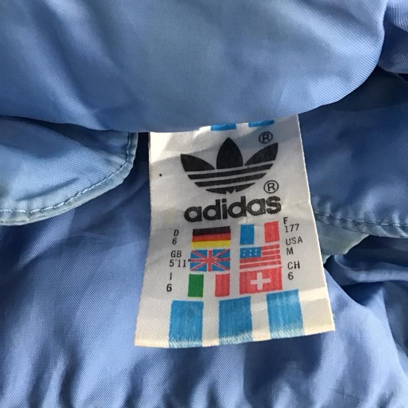 アディダス adidas ジャケット、上着 ジャケット、ブレザー 80s 万国旗 ナイロンジャケット スポーツウェア 古着 M ロゴ、文字 水色 / ライトブルー / メンズ USED 古着 中古 10121025