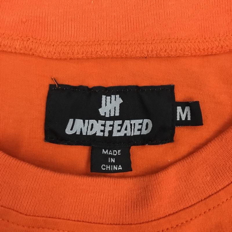 アンディフィーテッド UNDEFEATED Tシャツ 半袖 半袖カットソー プリントTシャツ クルーネックカットソー M プリント 橙 / オレンジ /  メンズ USED 古着 中古 10108964