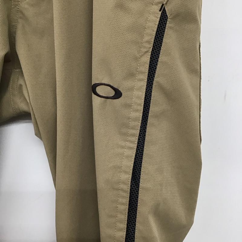 オークリー OAKLEY パンツ ワークパンツ、ペインターパンツ スリムパンツ ストレッチパンツ カジュアルパンツ 32インチ ロゴ、文字 ベージュ / ベージュ /  メンズ USED 古着 中古 10140280