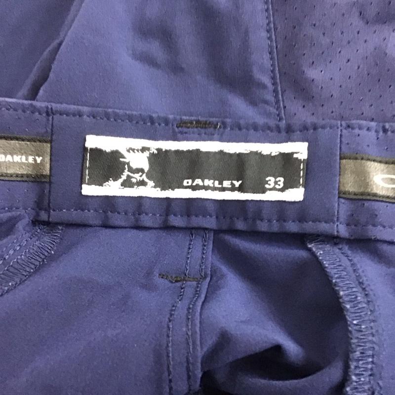 オークリー OAKLEY ボトムス ボトムス 422418JP ストレッチパンツ スポーツウェア ワンポイント 紺 / ネイビー /  メンズ USED 古着 中古 10146364