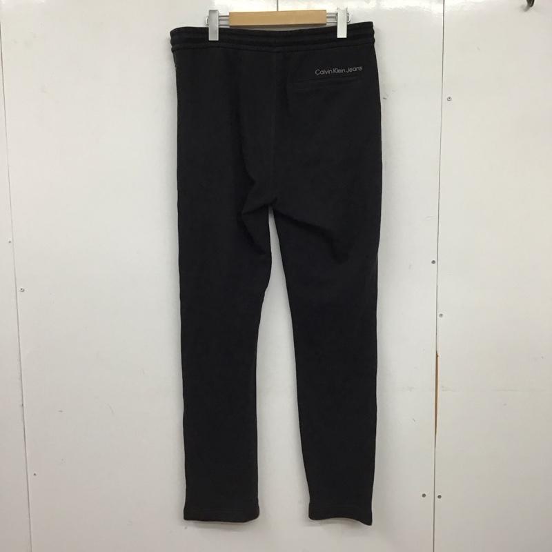 カルバン・クライン Calvin Klein パンツ ワークパンツ、ペインターパンツ スウェットパンツ ワイドパンツ カジュアルパンツ M ロゴ、文字 ダークグレー / ダークグレー / メンズ USED 古着 中古 10157593