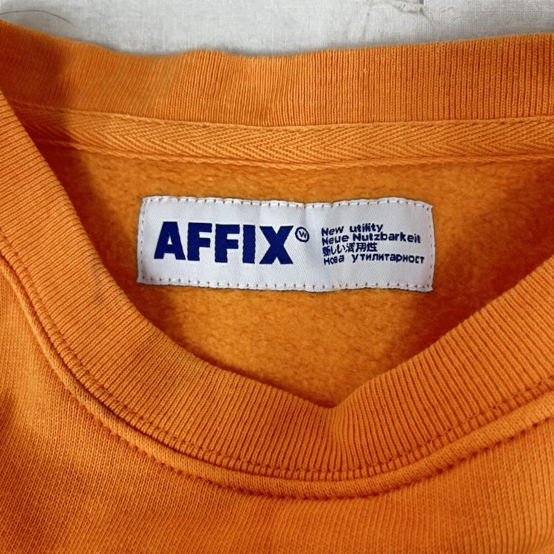 アフィックス AFFIX トレーナー 長袖 969784 new utility ワンポイント ロゴ 裏起毛 クルーネック L ロゴ、文字 橙 / オレンジ / orange メンズ USED 古着 中古 50160326